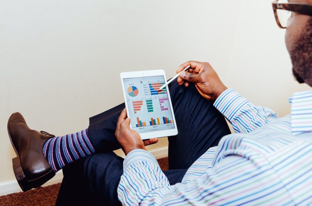 man working on a tablet with striped socks