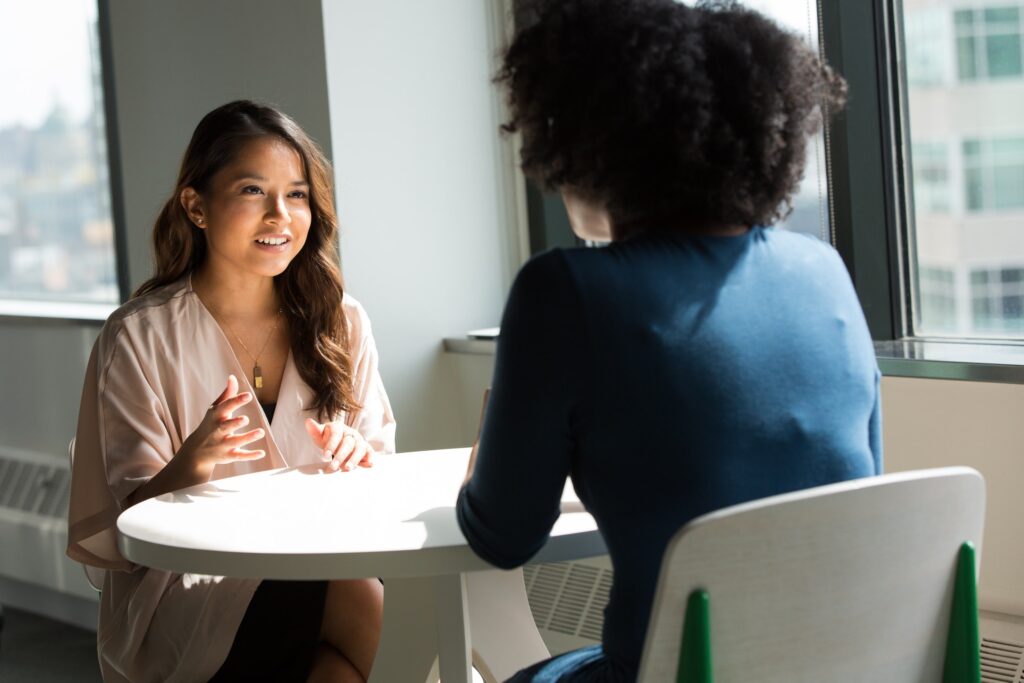 two women meeting around a table