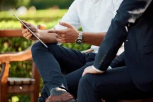 person sitting outside with a tablet