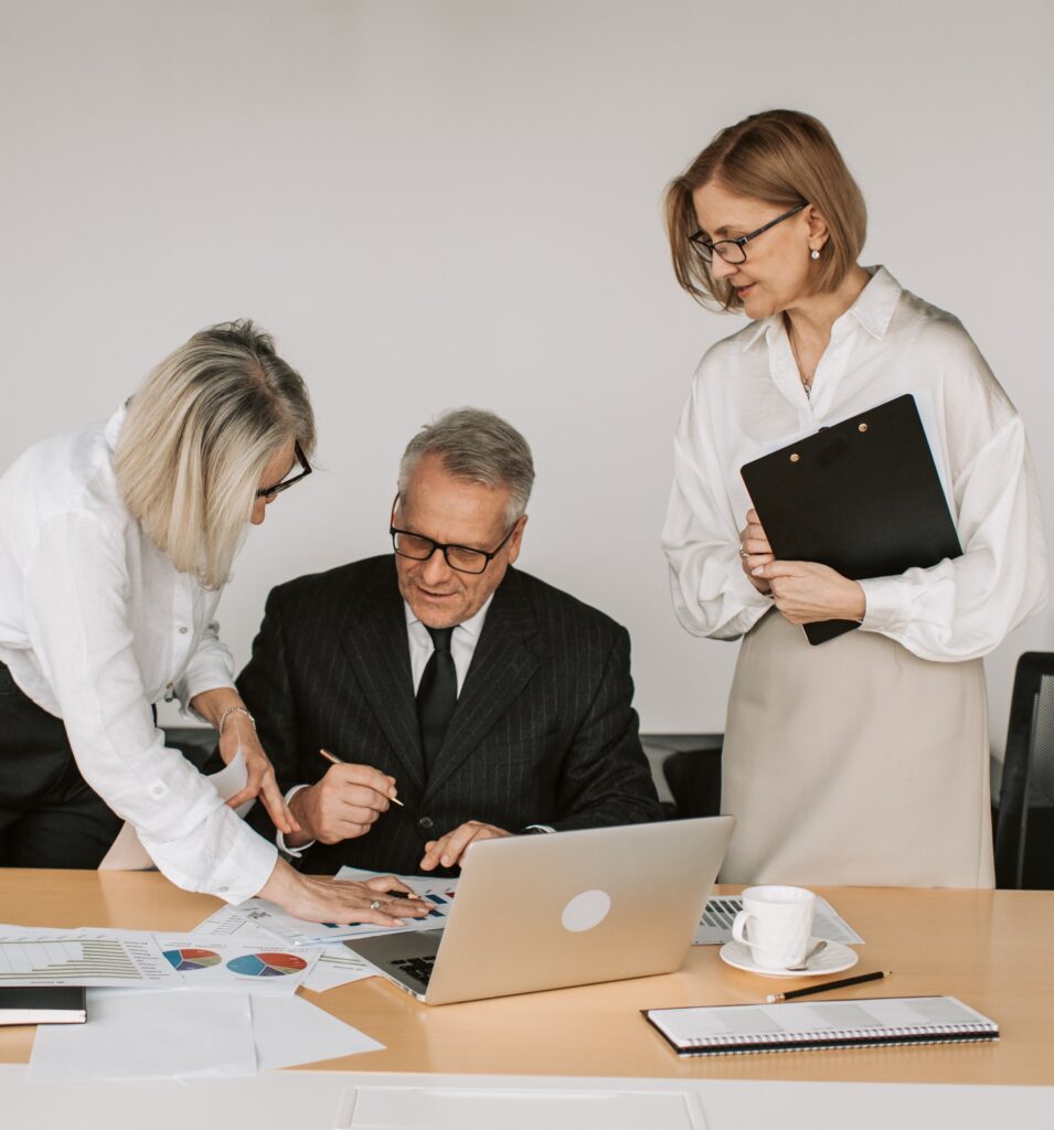 professionals meeting and discussing something behind a computer