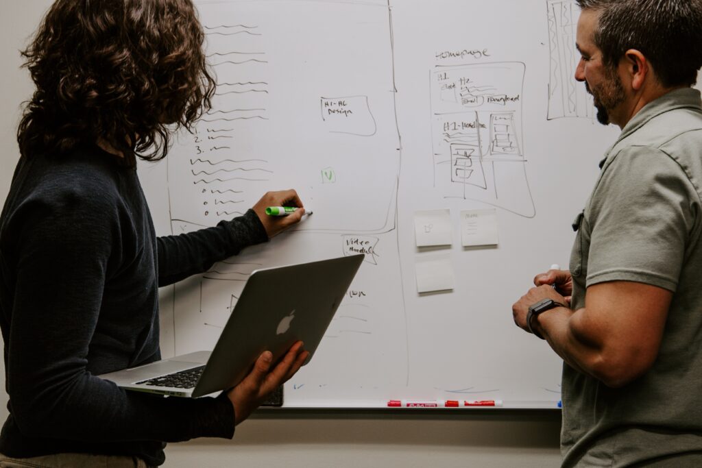 people writing on whiteboard