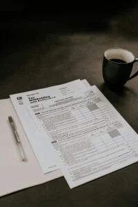 tax documents next to a cup of coffee